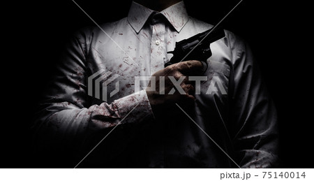 Horror scary photo of a killer in white shirt with blood splatter and posing with black gun. 75140014