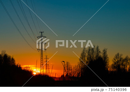 High voltage towers aganist the beautiful sunset 75140396