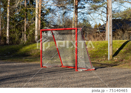 Red road hockey net on children playground in Finland Red road hockey net on children playground in Finland 75140465