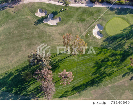 Aerial view over golf field. Aerial view over golf field. 75140649