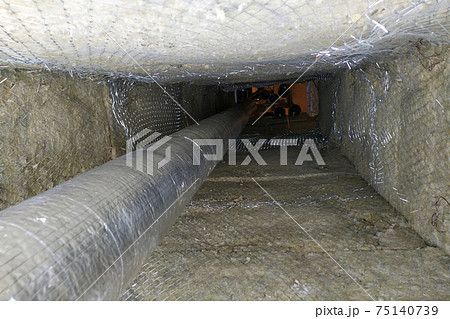 Installation of a ventilation pipe in the chimney, the pipe is wrapped with foil for cooling. 75140739