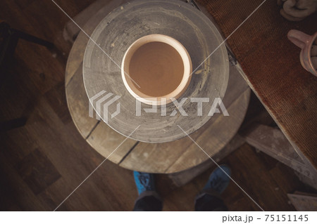 Clay pot on a potter's wheel 75151145