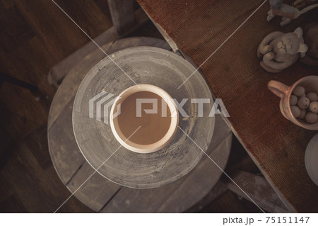 Clay pot on a potter's wheel 75151147