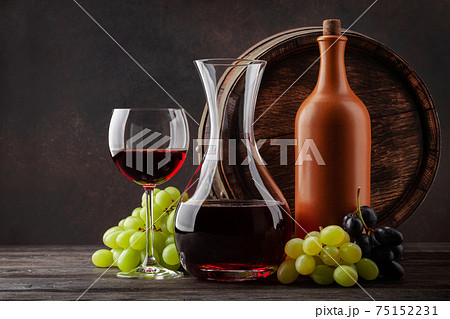 Wine bottle, decanter, glass and old wooden barrel Wine bottle, decanter, glass and old wooden barrel 75152231
