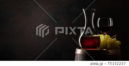 Wine decanter, glass and old wooden barrel Wine decanter, glass and old wooden barrel 75152237