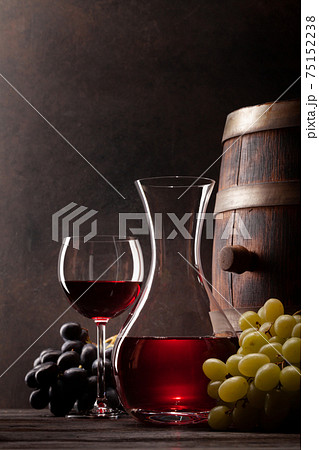 Wine decanter, glass and old wooden barrel Wine decanter, glass and old wooden barrel 75152238
