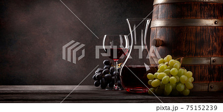 Wine decanter, glass and old wooden barrel 75152239