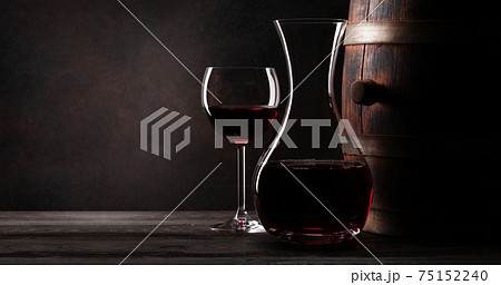 Wine decanter, glavss and old wooden barrel 75152240