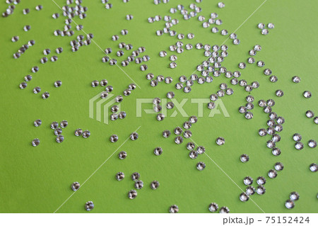 rhinestones on a green background, top photo. design for text rhinestones on a green background, top photo. design for text 75152424