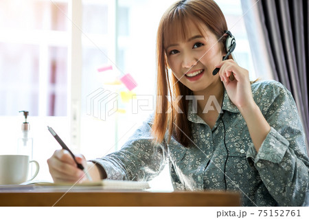 Businesswoman work from home wearing protection marks in covid-19 virus situation. Her working in quarantine for coronavirus and cleaning her hands with sanitizer or alcohol gel. Businesswoman work from home wearing protection marks in covid-19 virus situation. Her working in quarantine for coronavirus and cleaning her hands with sanitizer or alcohol gel. 75152761