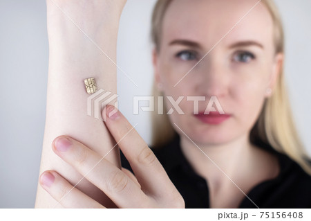 The woman shows his hand with a chip implanted. The concept of chipping and implantation of electronic technologies into the human body. Cybernetics and the nanofuture. Cyberpunk 75156408