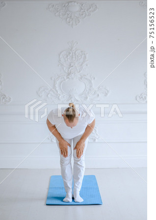 Man practicing advanced yoga against a white background 75156523