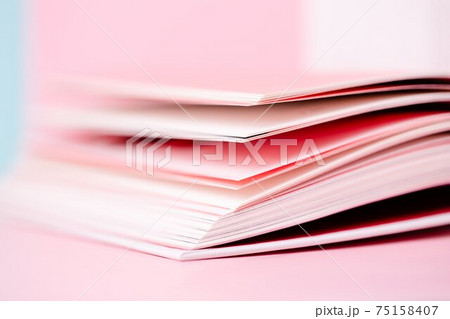 Close up book pages on pastel pink blurred background Close up book pages on pastel pink blurred background 75158407