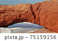Close-up of natural giant arch and a small man 75159156