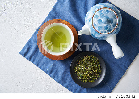 湯呑みに注がれた緑茶と茶葉 75160342