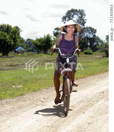 A happy girl ride a bicycle at Laos countryside A happy girl ride a bicycle at Laos countryside 75160903