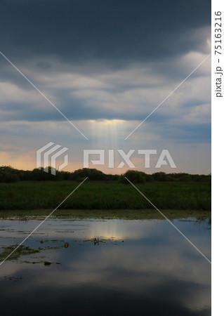 Dark sky before a thunderstorm overlooking the river. 75163216