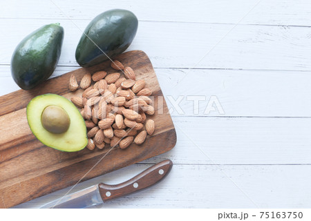 top view of slice of avocado and nut on chopping board with copy space top view of slice of avocado and nut on chopping board with copy space 75163750