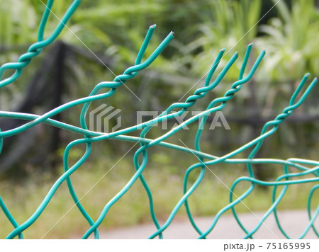 Unstable chain link fencing close up photo.  75165995