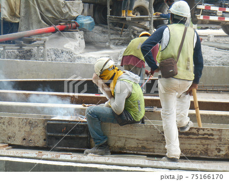 SELANGOR, MALAYSIA -MAY 16, 2017: Welder wearing protective mask during welding metal at the construction site. SELANGOR, MALAYSIA -MAY 16, 2017: Welder wearing protective mask during welding metal at the construction site. 75166170
