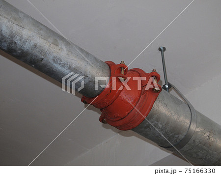 KAJANG, MALAYSIA -JUNE 16, 2017: Sprinkler system pipe in hang at the slab soffit. Sprinkler is an active fire fighting system in the building. KAJANG, MALAYSIA -JUNE 16, 2017: Sprinkler system pipe in hang at the slab soffit. Sprinkler is an active fire fighting system in the building. 75166330