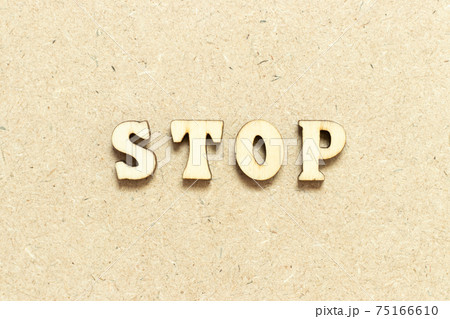 Alphabet letter in word stop on wood background 75166610