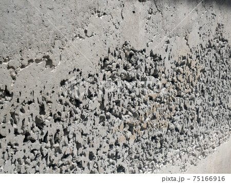 New fresh concrete surface with honeycomb problem and might expose reinforcement bar inside. The problem weakens concrete strength.  75166916