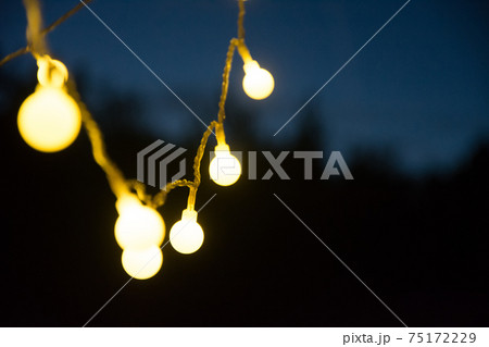 Chain of lights brings light into the dark night - a cozy atmosphere Chain of lights brings light into the dark night - a cozy atmosphere 75172229