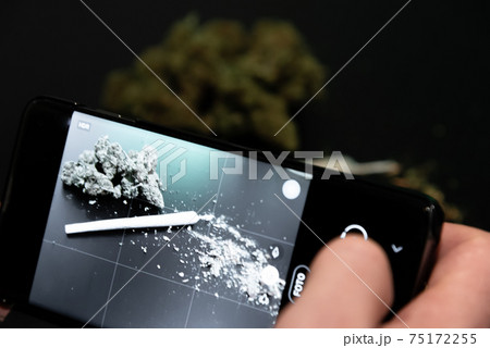 Taking a picture of a perfectly rolled joint with a smartphone Taking a picture of a perfectly rolled joint with a smartphone 75172255