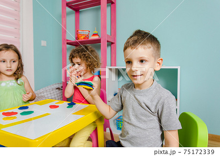 the child enjoys his work at the kindergarten 75172339