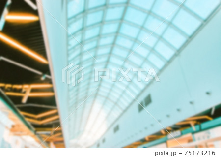 Bokeh Shopping mall background. Interior of retail centre store in soft focus. People shopping in modern commercial mall center. Fashion market hall. Bokeh Shopping mall background. Interior of retail centre store in soft focus. People shopping in modern commercial mall center. Fashion market hall. 75173216