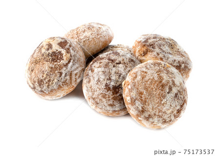 Gingerbread cookies on a white background. Homemade gingerbread cookies close-up. Gingerbread cookies on a white background. Homemade gingerbread cookies close-up. 75173537