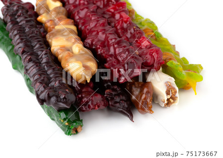 Churchkhela on a white background. Georgian sweet closeup on a white background. Churchkhela on a white background. Georgian sweet closeup on a white background. 75173667