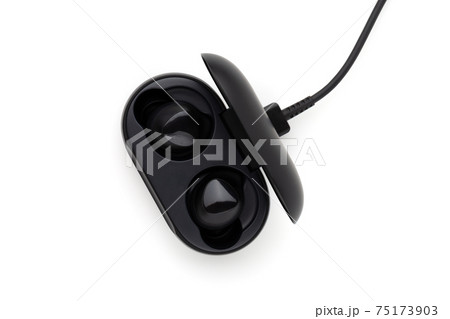 Wireless headphones on a white background. Headset close up in the charging case close-up. 75173903