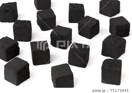 Coconut charcoal on a white background. Coconut coal cubes for hookah close-up. Coconut charcoal on a white background. Coconut coal cubes for hookah close-up. 75173945