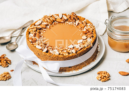 Cheesecake with salted caramel and nuts. Cheesecake with salted caramel and nuts. 75174083