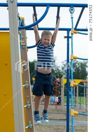 a boy plays on the Playground. playground. a boy plays on the Playground. playground. 75174352