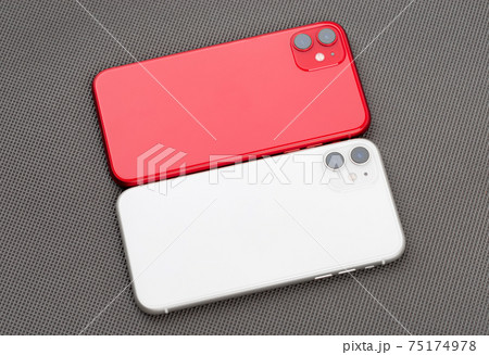 Two smartphones on a gray background. Two smartphones on a gray background. 75174978