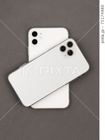Two smartphones on a gray background. Two smartphones on a gray background. 75174980