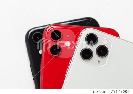 Three smartphones close-up on a white background. Three smartphones close-up on a white background. 75175002