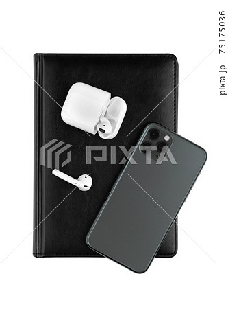 A smartphone with three cameras, a smartwatch and wireless headphones on a white background. A smartphone with three cameras, a smartwatch and wireless headphones on a white background. 75175036