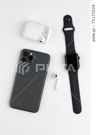 A smartphone with three cameras, a smartwatch and wireless headphones on a white background. A smartphone with three cameras, a smartwatch and wireless headphones on a white background. 75175038