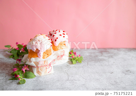 Traditional Easter bread or cake, decorated with sugar decor icing and berries on grey background. Happy Easter Holidays. Copy space. Traditional Easter bread or cake, decorated with sugar decor icing and berries on grey background. Happy Easter Holidays. Copy space. 75175221