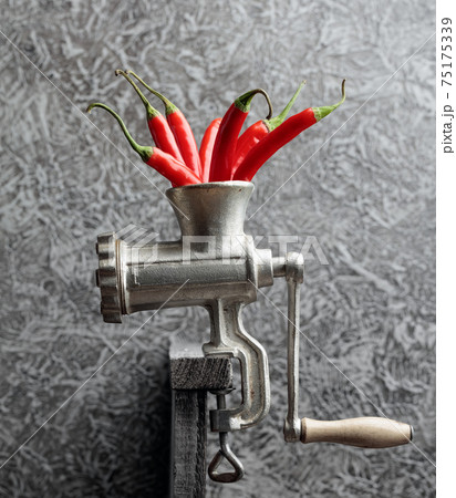 Red hot chili pepper in grinder. 75175339