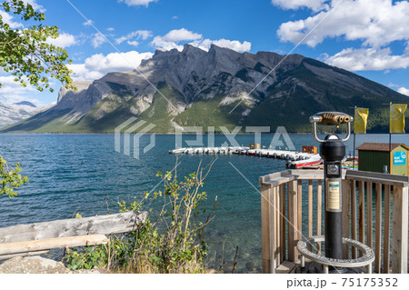 Lake Minnewanka beautiful landscape in summer day. Famous tourist attraction for leisure activities, boat cruise and mountain trail hiking in Banff National Park, Canadian Rockies. Lake Minnewanka beautiful landscape in summer day. Famous tourist attraction for leisure activities, boat cruise and mountain trail hiking in Banff National Park, Canadian Rockies. 75175352