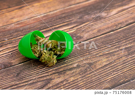 A Green Open Easter Egg With Cannabis Coming Out of It 75176008