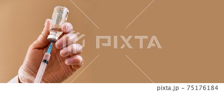Nurse holding syringe and vaccine against covid Nurse holding syringe and vaccine against covid 75176184
