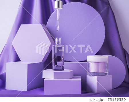 Hyaluronic acid bottle on purple background displayed on geometric shape podiums on silk background Hyaluronic acid bottle on purple background displayed on geometric shape podiums on silk background 75176529