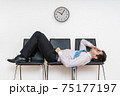 Tired bored man is sleeping in waiting room on chairs. 75177197