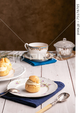 Vanilla cream puffs on a wooden table Vanilla cream puffs on a wooden table 75178705